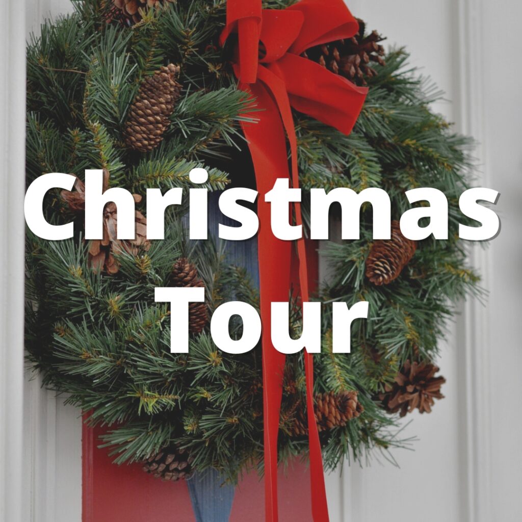 Image of a wreath on a door with the text "Christmas Tours".